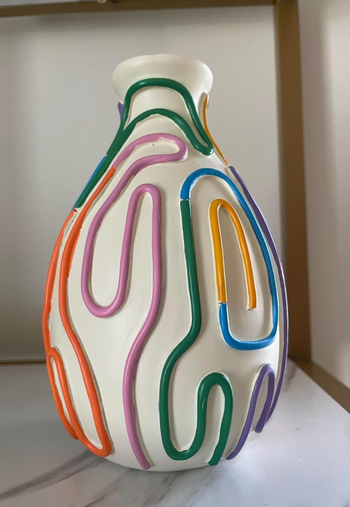 An intricately designed vase with colorful, abstract raised lines, ideal for modern home decor.