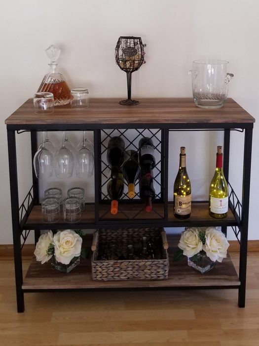 Reviewer image of a wooden and metal bar cabinet with a wine rack
