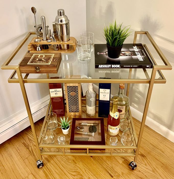 a photo from a reviewer showing the gold bar cart with drinks placed on both of its tiers