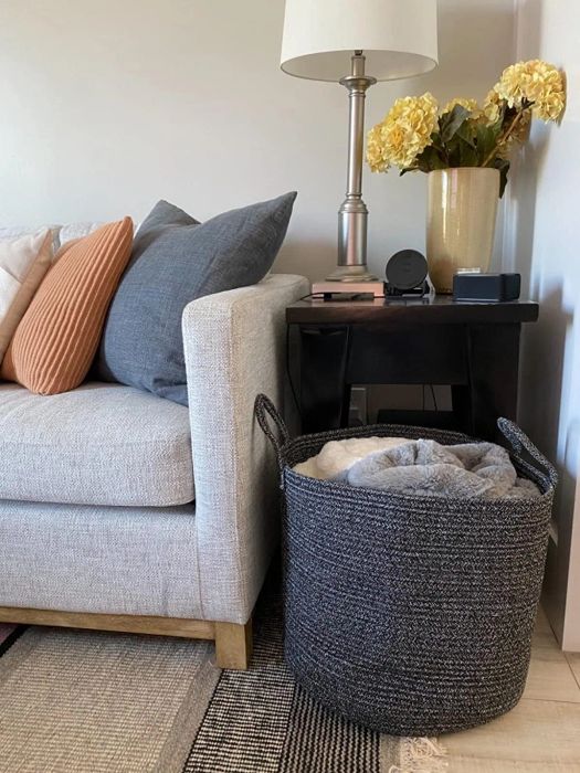 the grey basket stacked with blankets