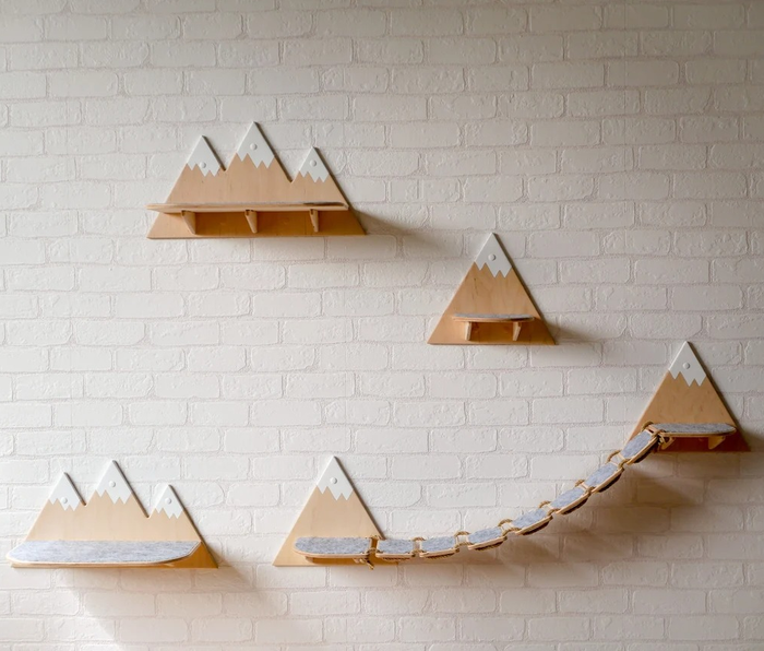 Individual shelves shaped like triangular mountain peaks, with one set featuring a connecting bridge.