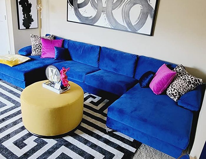 Close-up shot of a blue couch adorned with vibrant throw pillows