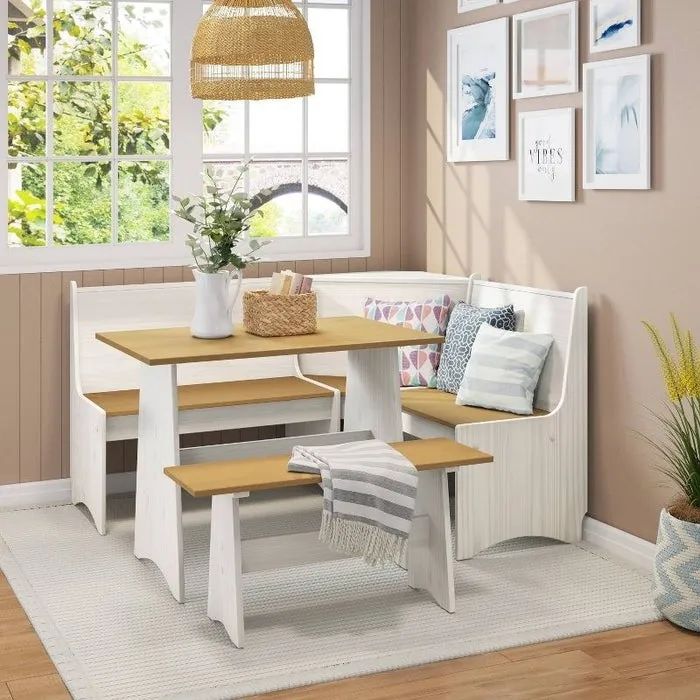 A white and honey breakfast nook placed beneath a window