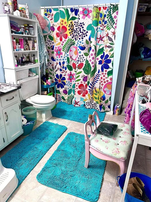 A floral shower curtain featuring a white background with vibrant flowers