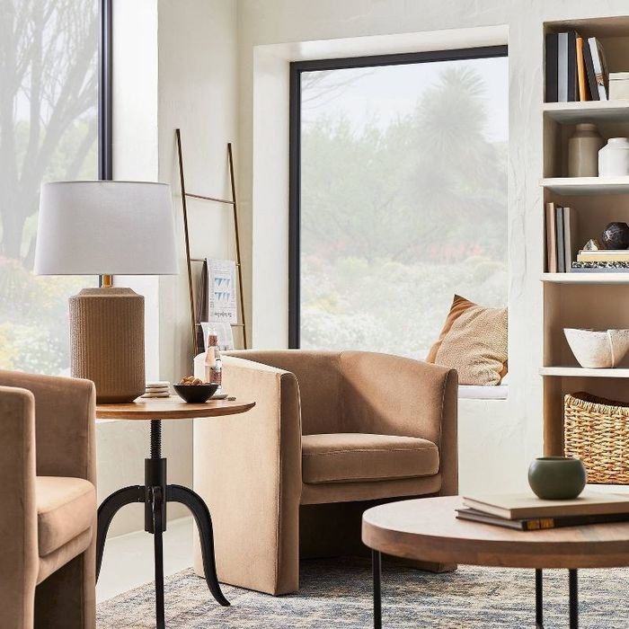 An image of a barrel accent chair with soft fabric upholstery and a padded seat.