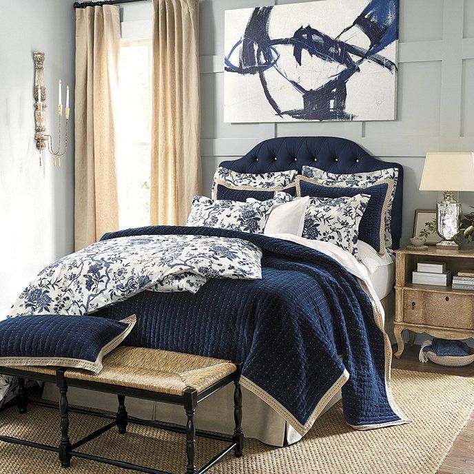 beige rattan bench placed at the foot of the bed