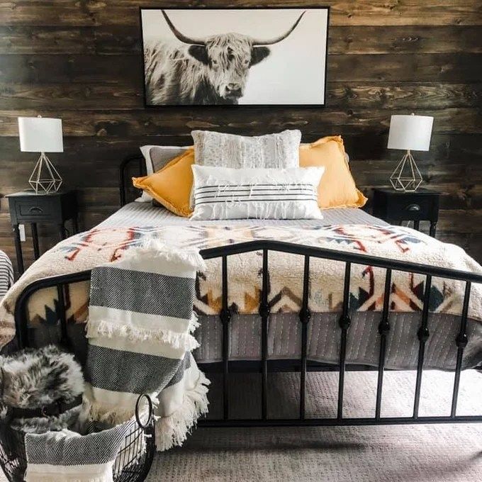 A bedroom featuring a bed with a sleek metal bedframe
