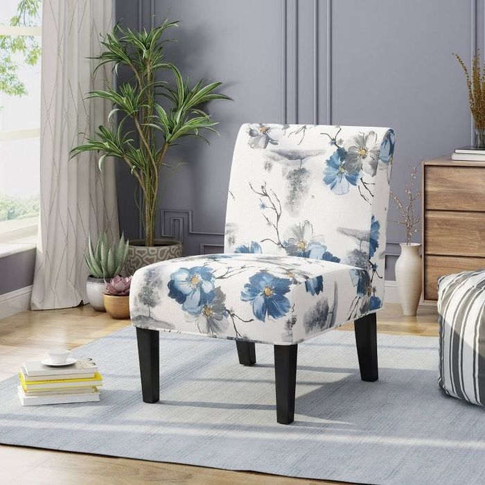 An image of a floral accent chair featuring durable wood construction, rubberwood legs, and plush cushioned seating.