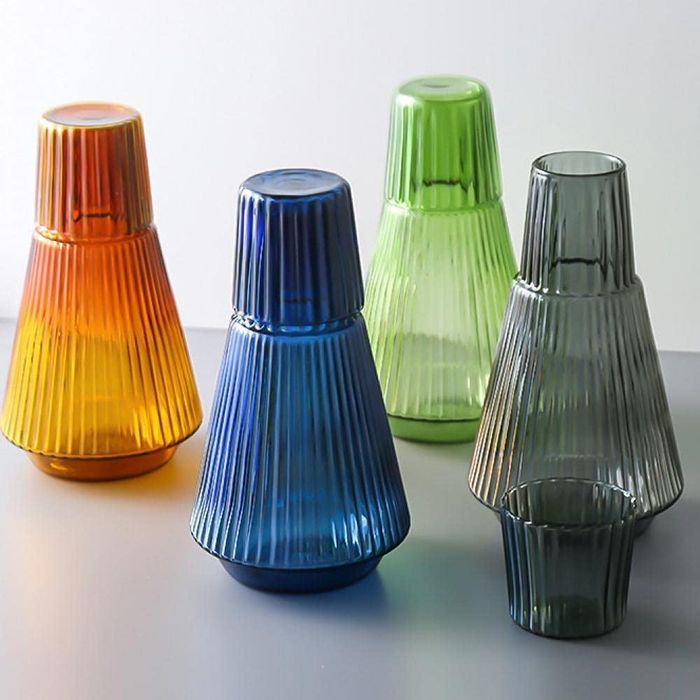 Four different color carafes with coordinating cups