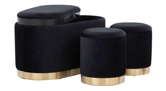 A set of three black and gold storage ottomans stacked neatly together, adding both function and elegance to the room.