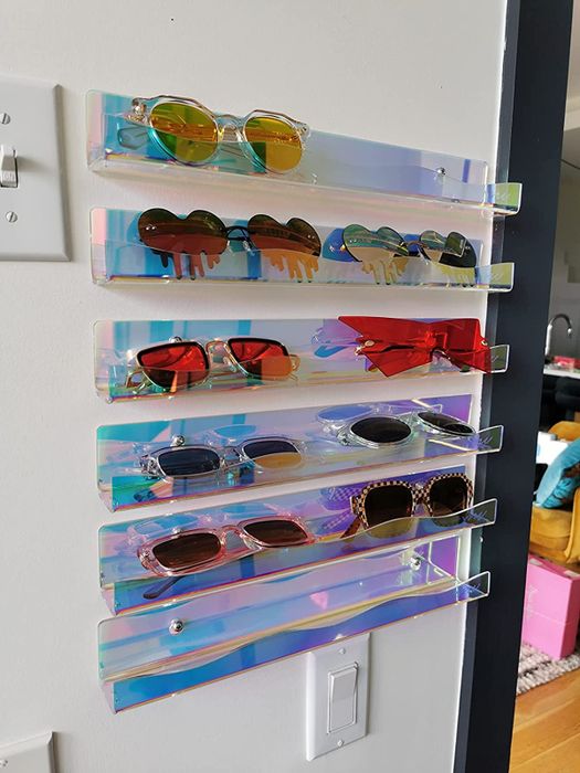 A reviewer showcases the six shelves holding sunglasses