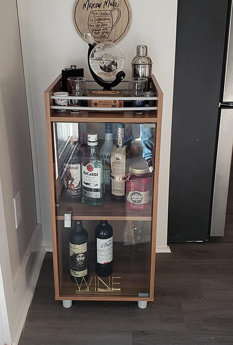 Reviewer image of a wooden mini bar cabinet tucked in the corner of a room