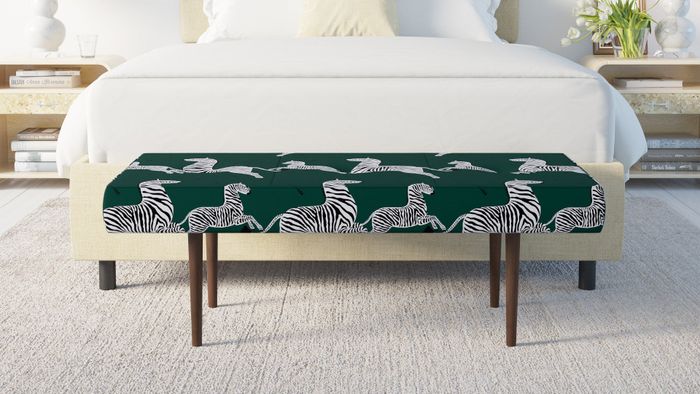 green zebra print bench placed at the foot of a bed
