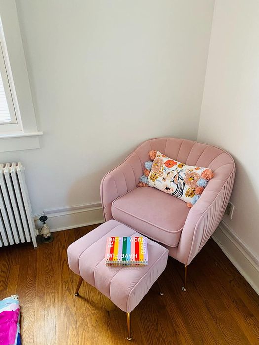 A reviewer displays their pink set in a cozy room corner