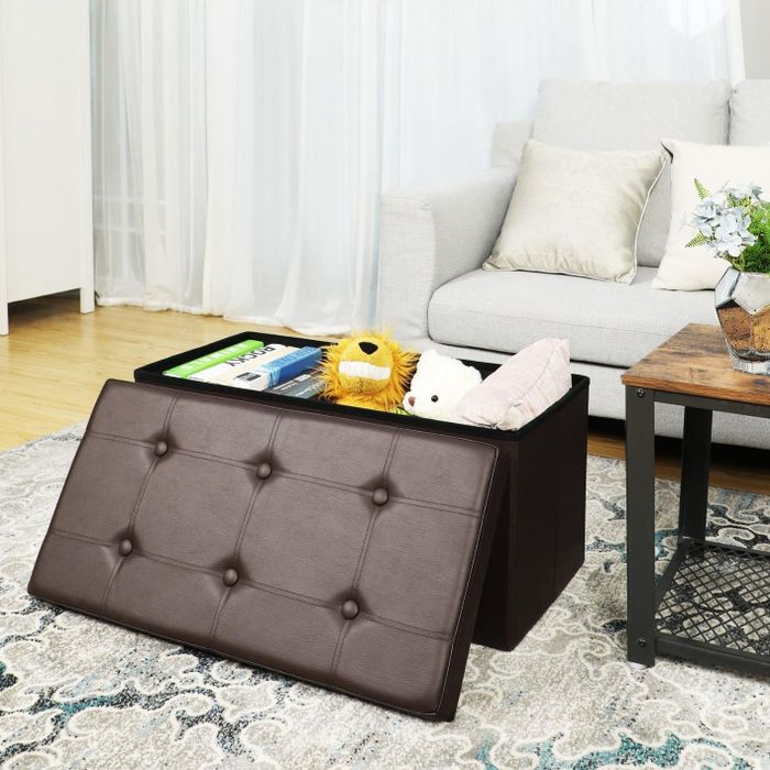 reviewer photo of a brown faux leather storage ottoman filled with children's toys