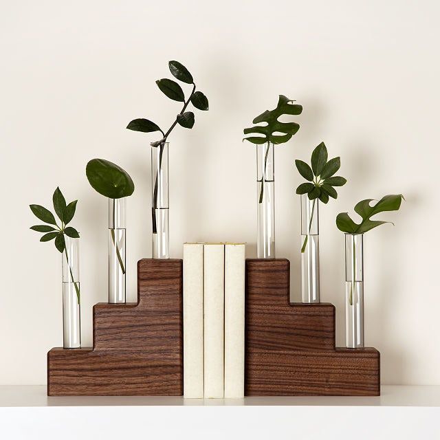 Two walnut bookends supporting three books