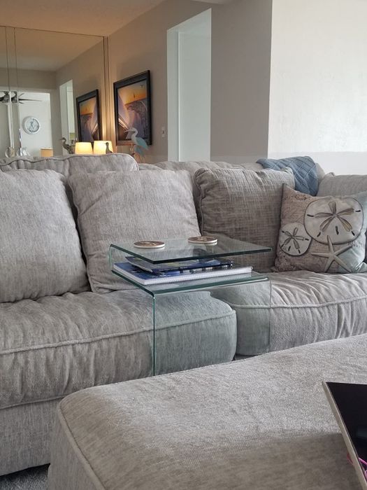 A different reviewer photo of the nightstand placed right next to a couch