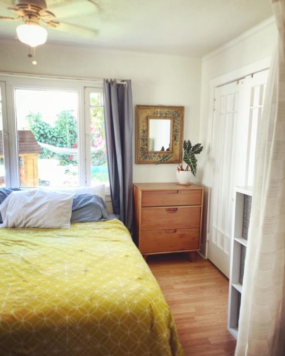 Reviewer photo of a wooden dresser next to a bed
