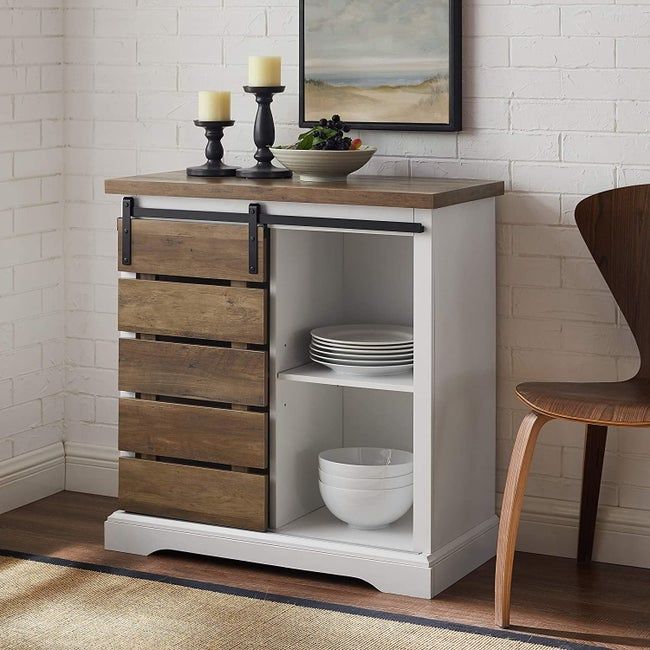 The white buffet featuring a dark wooden sliding door