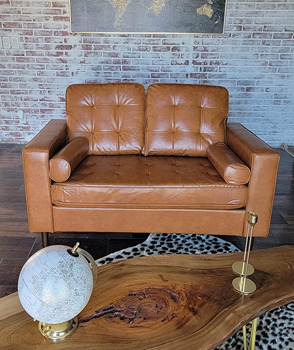 Reviewer image of a tan faux leather loveseat