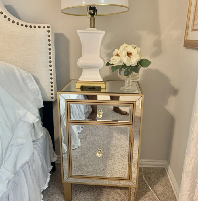 The mirrored nightstand with gold accents