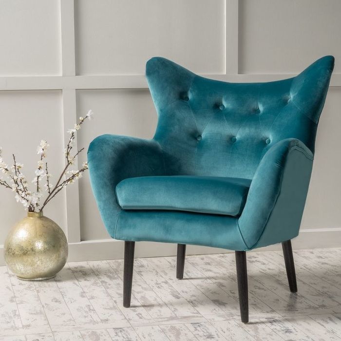 An image of a teal velvet armchair.