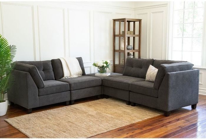 the grey sectional with the ottoman as the corner piece