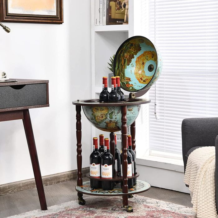 Blue globe-shaped bar cabinet stocked with wine bottles