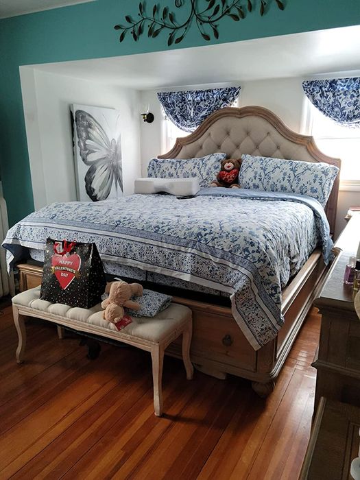 reviewer photo of a white bench placed at the foot of the bed