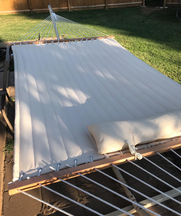 Close-up photo of the white hammock secured to the spreader bar.