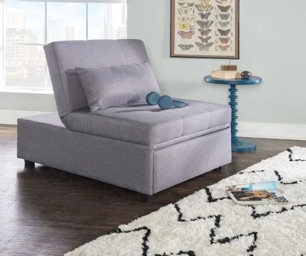 A gray sofa chair with headphones placed on it.