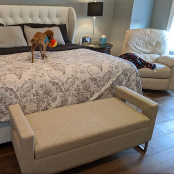 reviewer photo of the bench placed at the end of a bed