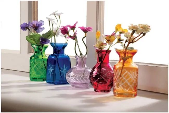 Five small glass vases in varying sizes, with etched designs on the bases, in colors like green, blue, purple, red, and orange