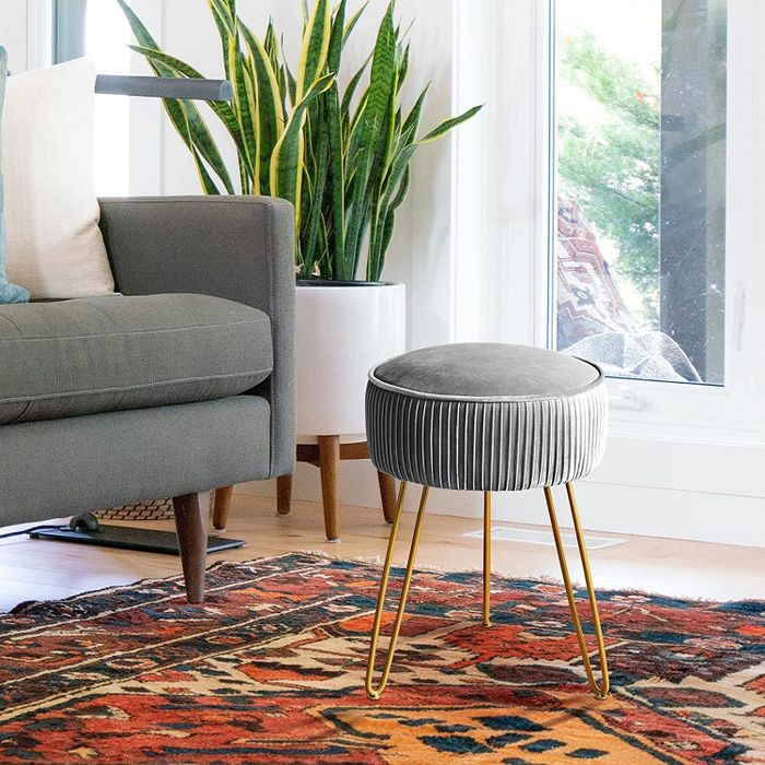 The gray pleated footstool in a cozy living room setting