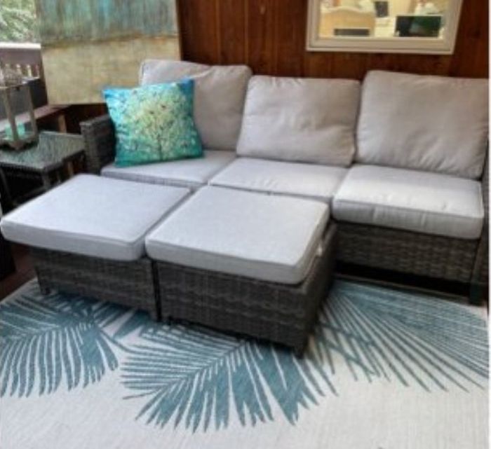 Reviewer photo of a cream-colored sofa with two ottomans.