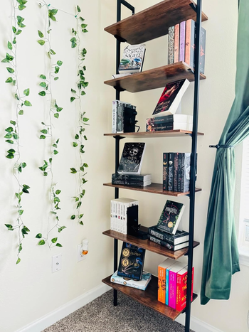 A wooden bookshelf filled with various books