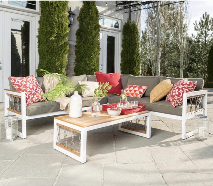 Photo of an outdoor sectional with gray and red cushions set on a patio.