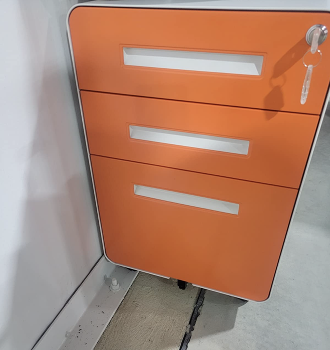 A reviewer's photo of a vibrant orange file cabinet