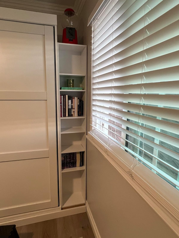 A bookcase tucked into a tiny corner