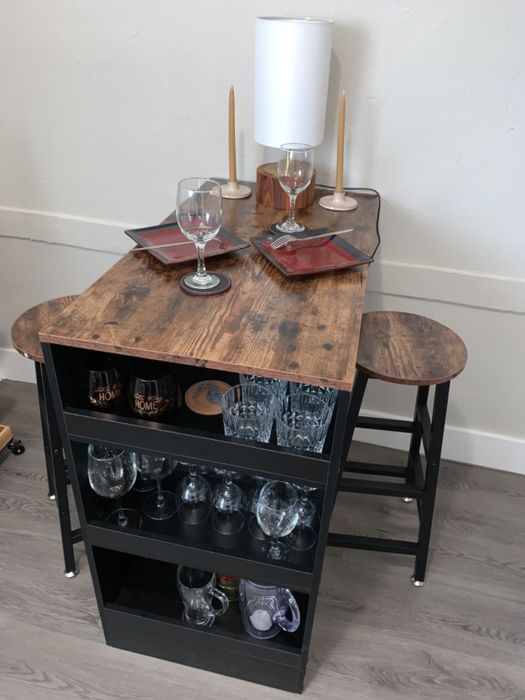 black and wooden table with stools