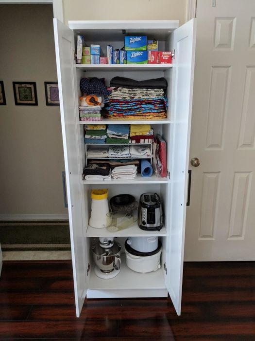Another reviewer’s photo featuring the same narrow white storage closet against a wall with its doors securely shut