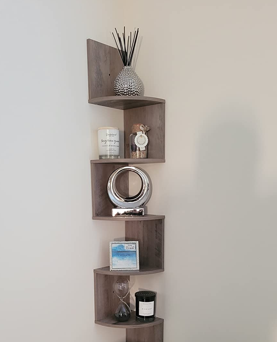 A reviewer image of a light brown product adorned with candles and decorative knick-knacks