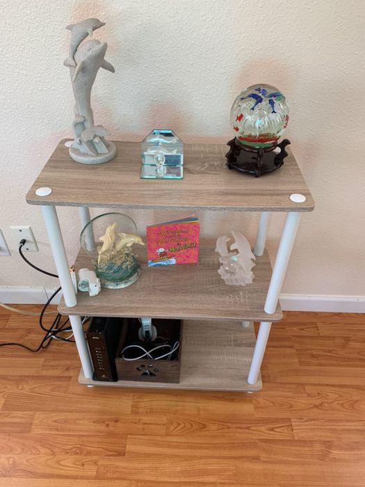 Image from a reviewer showing a white and oak shelf adorned with various knick-knacks
