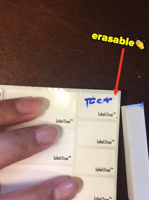 A reviewer tests the erasable marker on a label to see how easily it comes off.
