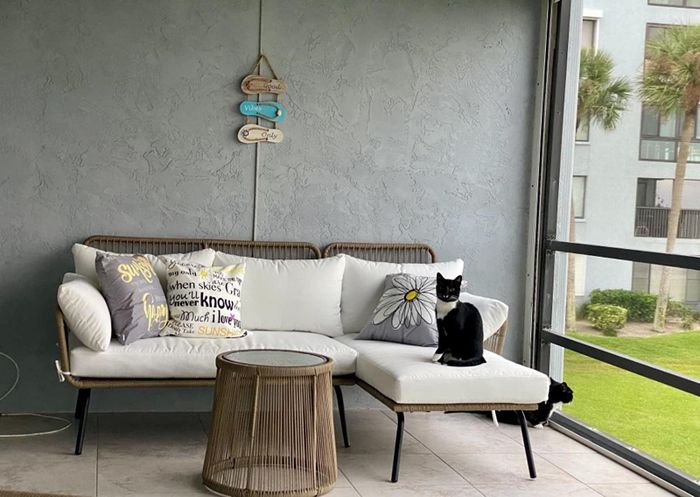Reviewer photo of an L-shaped couch with a black-and-white cat lounging on it.