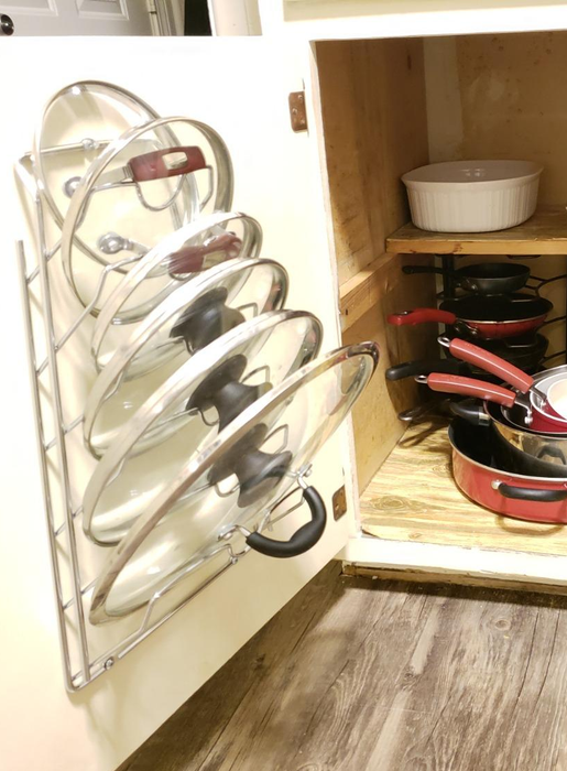 A reviewer demonstrates using the organizer to store their pot lids neatly.