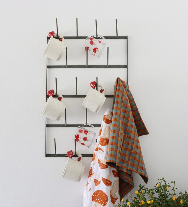 The black hanging mug rack, neatly arranged with mugs.