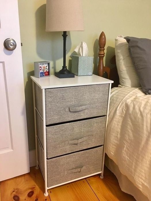 A reviewer's nightstand adorned with a lamp, tissues, and other decorative items