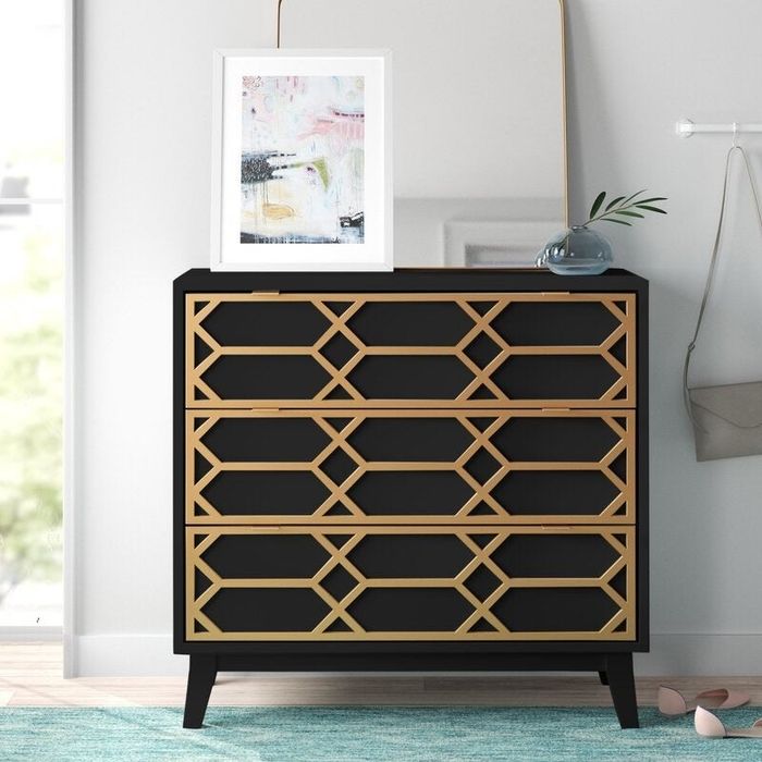 black chest with a gold crisscross design on the front