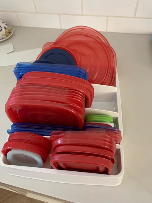 The organizer in a reviewer's drawer, neatly holding a variety of container lids.